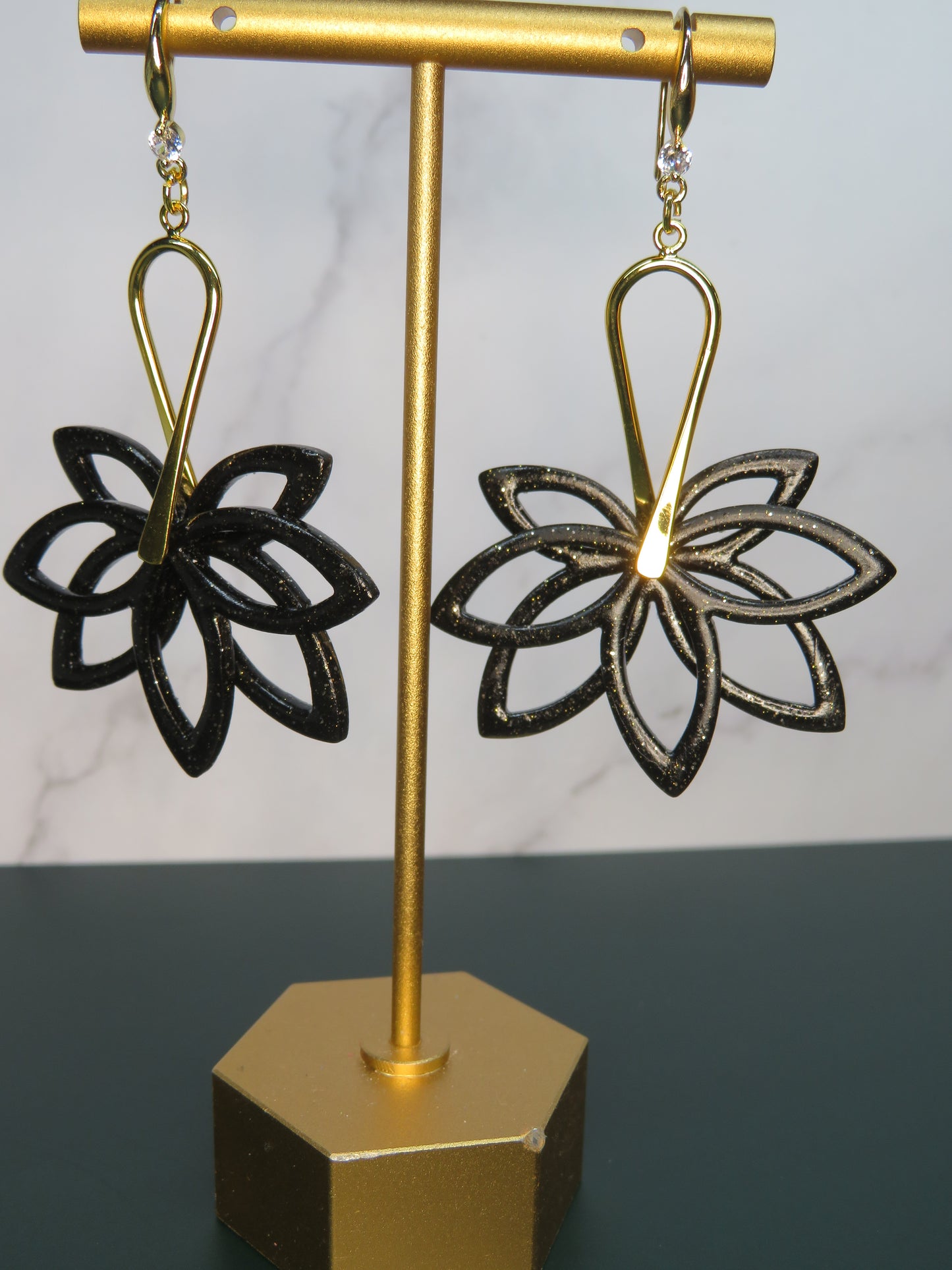 Flower double dangle earrings in black with gold sparkles
